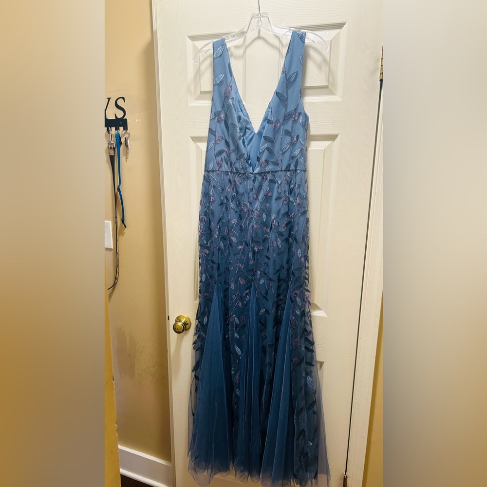 Elegant sleeveless sequined fish tail  full length gown.